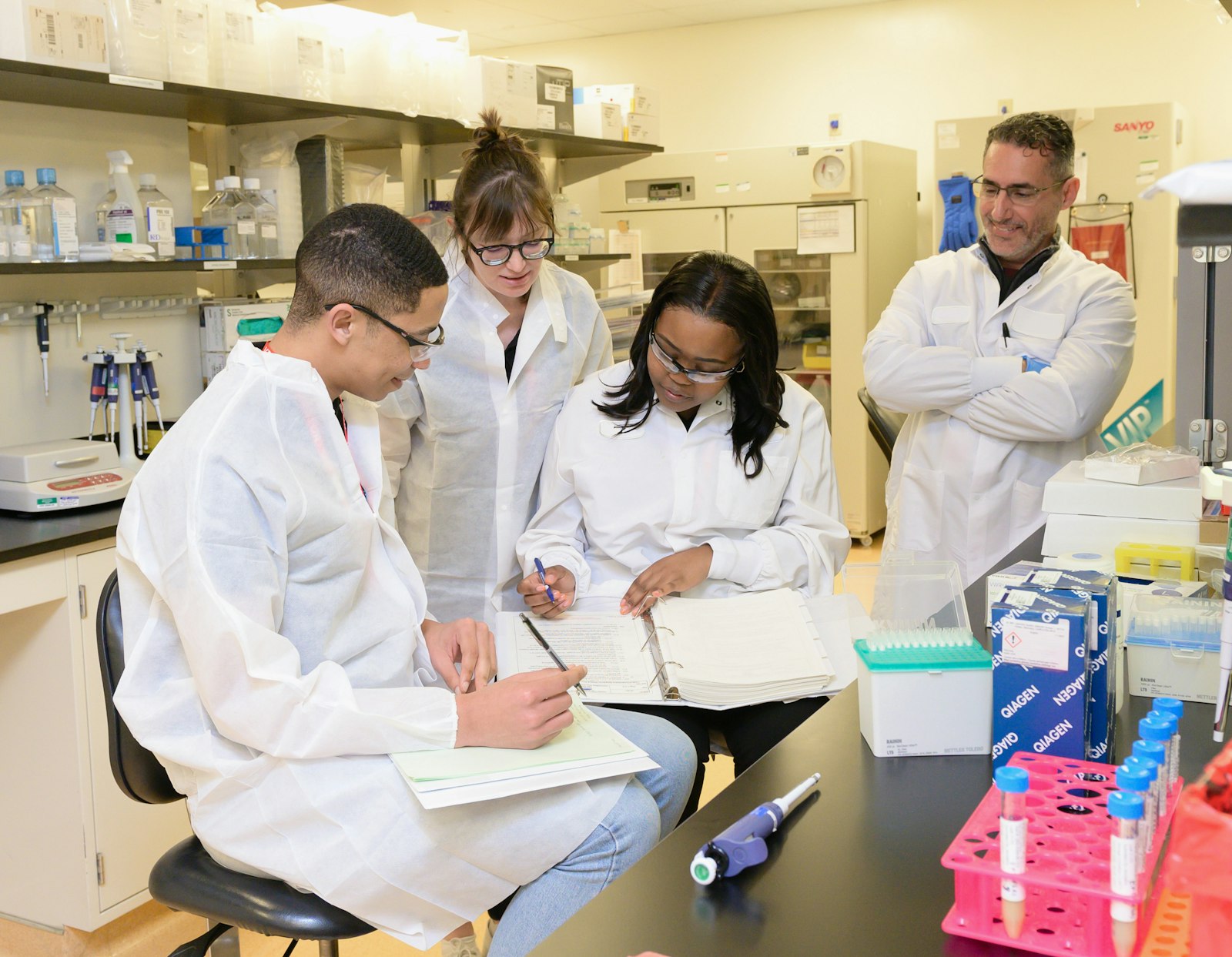 Trainees learning in a clinical research lab